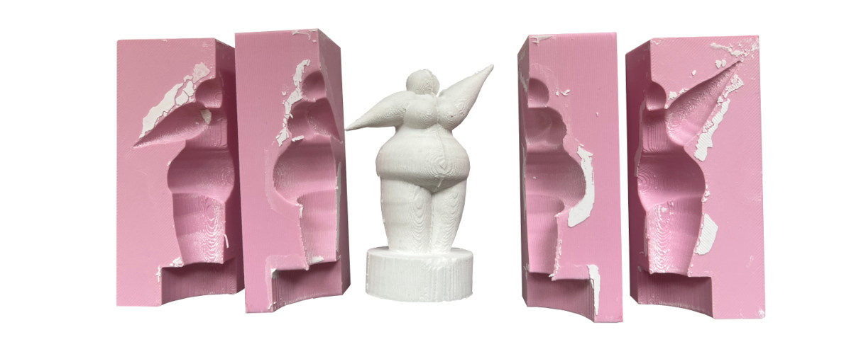 Foto: Rosafarbene Silikon-Gussformen mit den Abdrücken einer 3D-gedruckten Figur sowie mittig den fertigen weißen Gipsabguss dieser Figur.